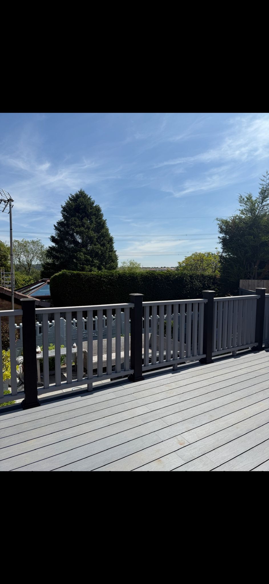 Composite deck with mixed black and white railings