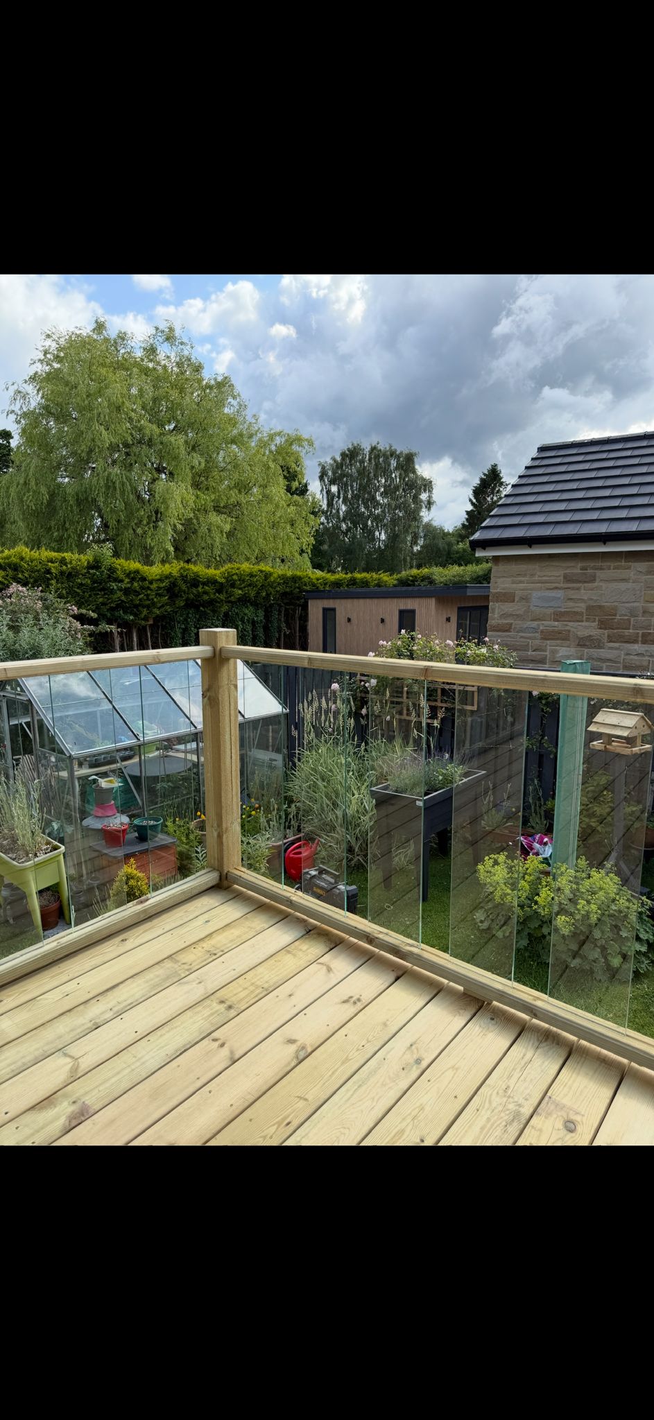 Glass balustrade decking with garden view